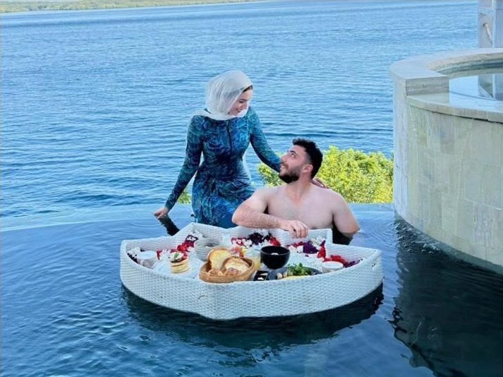 Ahmed and Habiba with a floating breakfast in an infinity pool overlooking the sea in Bali